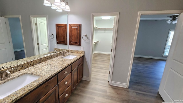 bathroom with hardwood / wood-style flooring, ceiling fan, and vanity