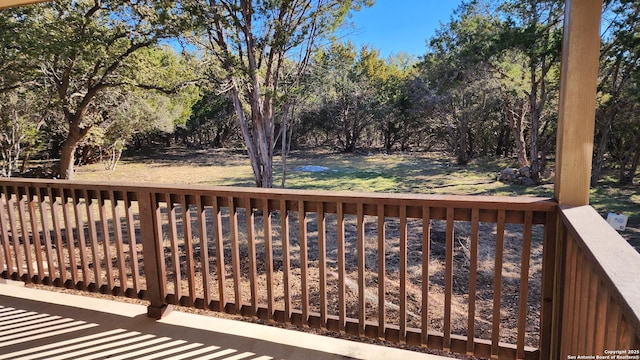 909 Marlys Ave, Canyon Lake, TX 78133 - wooden deck with view of scattered trees