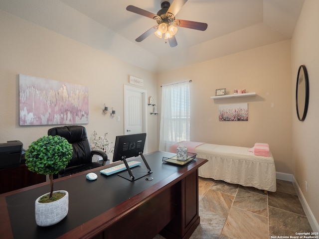 office area featuring baseboards, a ceiling fan, a raised ceiling, and lofted ceiling