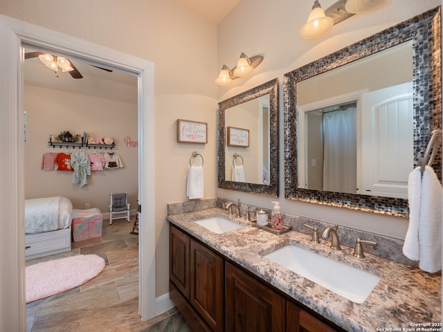bathroom with double vanity, baseboards, a sink, and ceiling fan