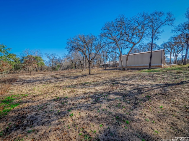 view of yard featuring an outbuilding and an outdoor structure