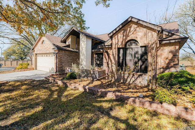 view of front of house with a garage and a front lawn