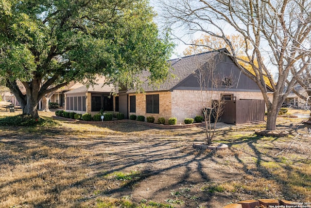 view of front of house featuring a sunroom