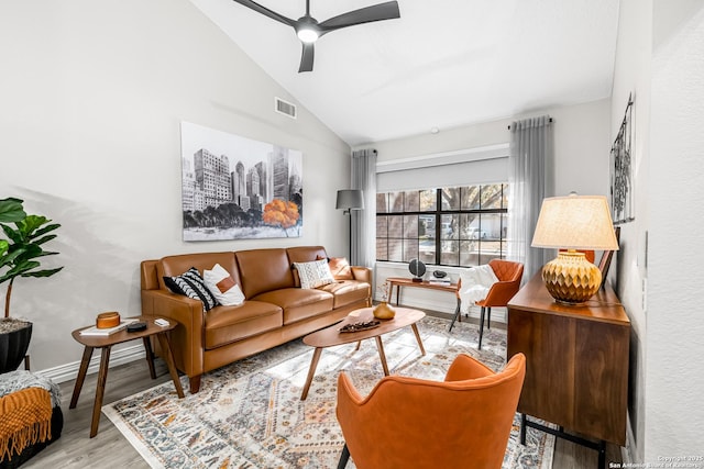 living room featuring lofted ceiling, light hardwood / wood-style flooring, and ceiling fan