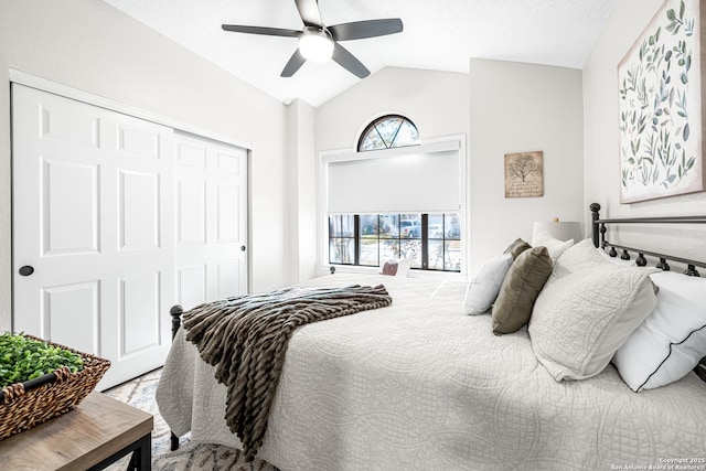 bedroom with lofted ceiling, ceiling fan, and a closet