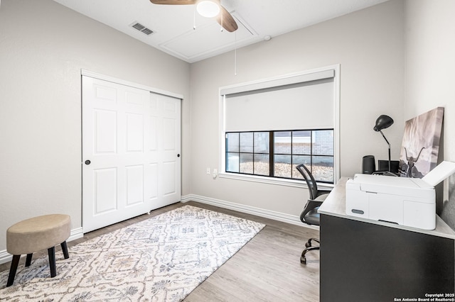 office with hardwood / wood-style flooring and ceiling fan