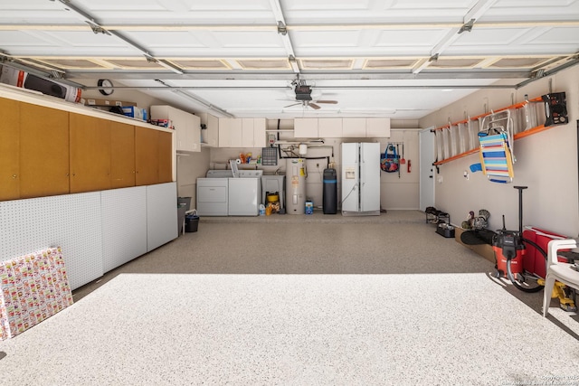 garage featuring electric water heater, a garage door opener, white refrigerator with ice dispenser, and independent washer and dryer