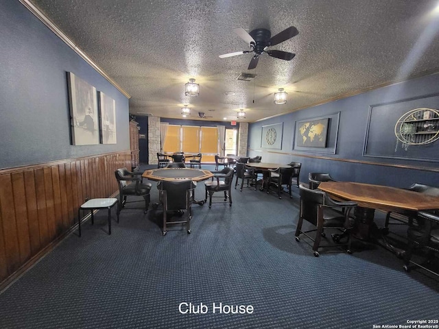 3601 Elm Ct, Schertz, TX 78108 - dining room with a ceiling fan, carpet flooring, a textured ceiling, and crown molding