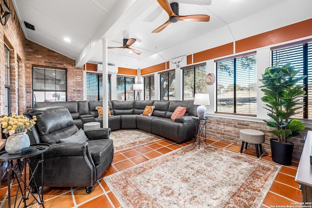 living room with lofted ceiling, tile patterned flooring, ceiling fan, and brick wall