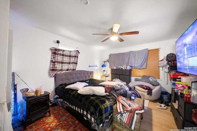 bedroom with ceiling fan and light hardwood / wood-style flooring