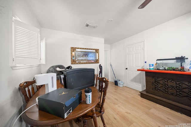 dining space with ceiling fan and light wood-type flooring