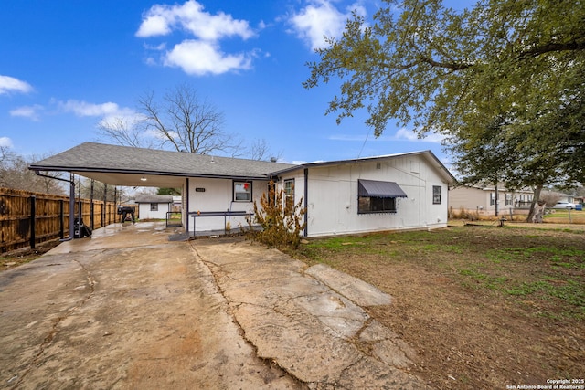 back of property with a carport