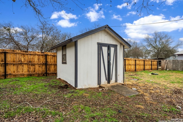 view of outbuilding featuring a lawn