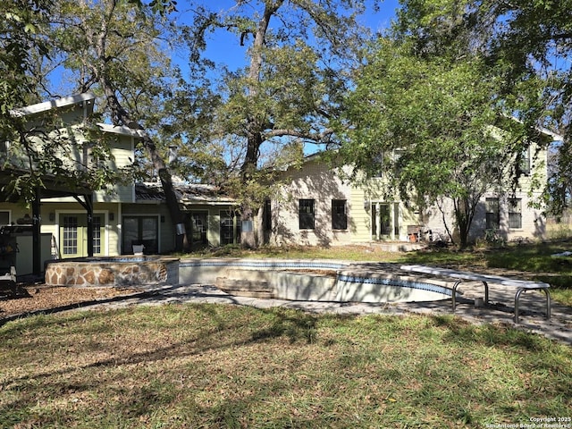 back of house featuring a yard and a patio