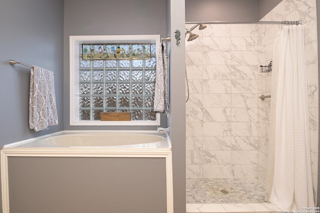 bathroom with a shower stall and a bath