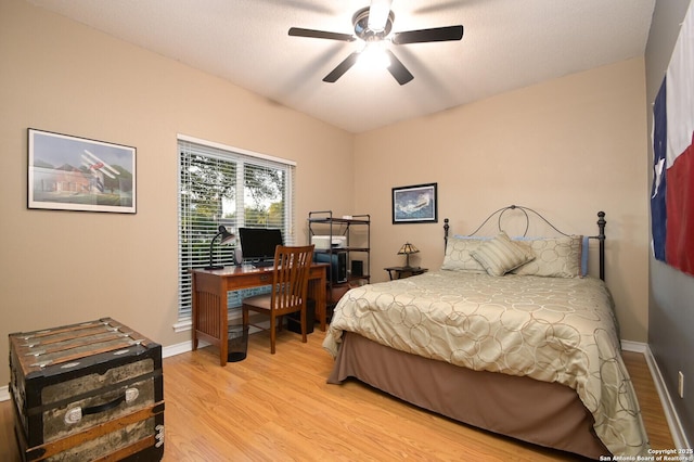 bedroom featuring light wood finished floors, ceiling fan, and baseboards