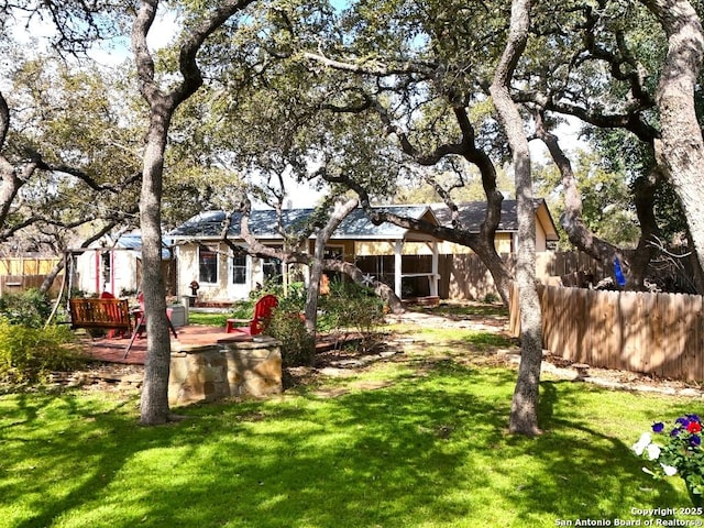 view of yard with fence and a deck