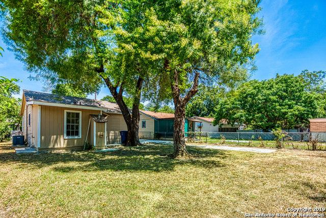 exterior space with central AC and a lawn