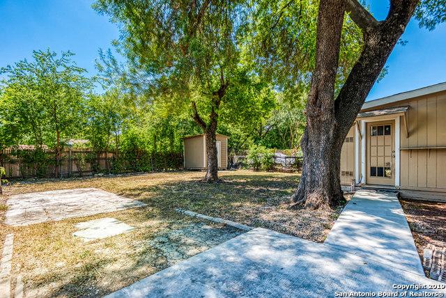 view of yard featuring a storage unit and a patio area