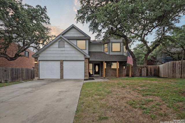 view of front facade with a garage and a yard