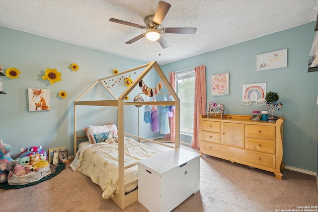 carpeted bedroom with ceiling fan and a textured ceiling