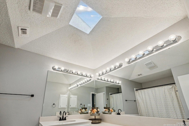 bathroom with vanity and a textured ceiling