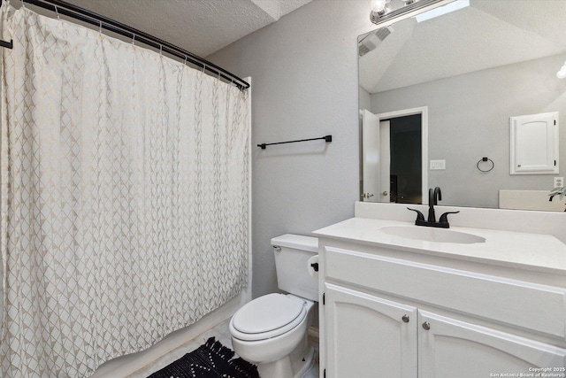 bathroom featuring vanity, curtained shower, toilet, and a textured ceiling