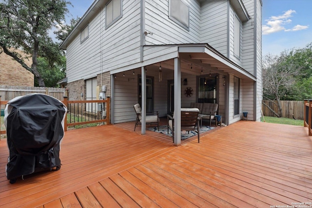 wooden terrace featuring a grill