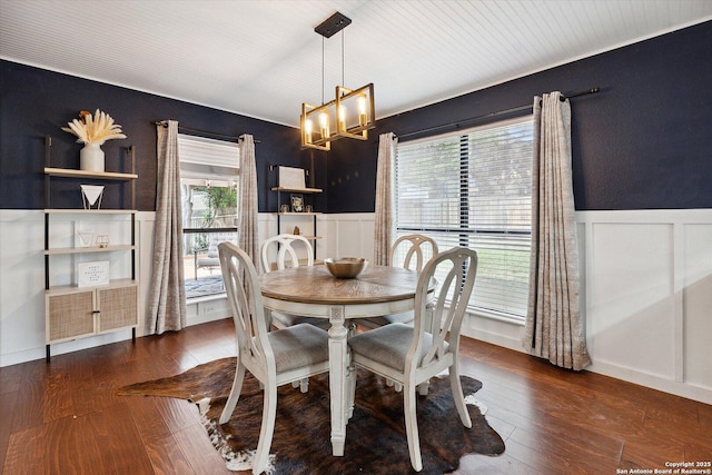 dining area featuring dark hardwood / wood-style floors and a notable chandelier