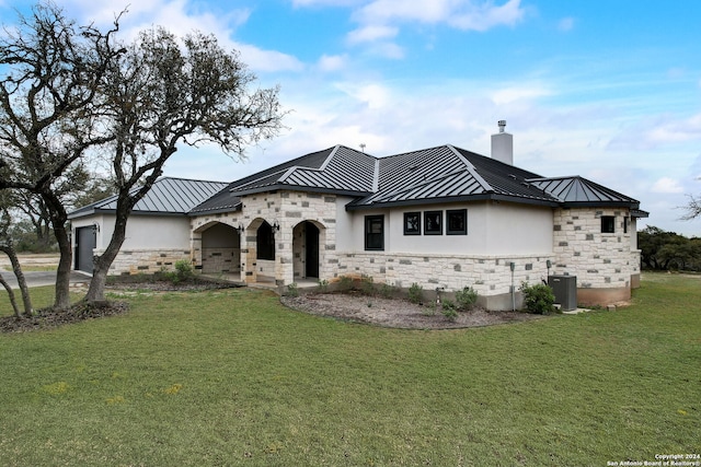 view of front of property featuring a front yard and central air condition unit