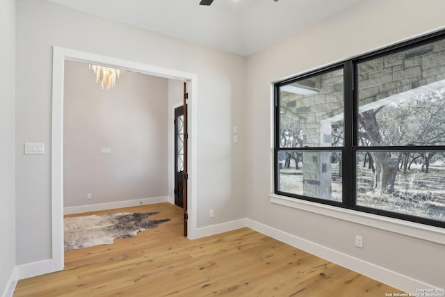 unfurnished room with hardwood / wood-style floors and ceiling fan