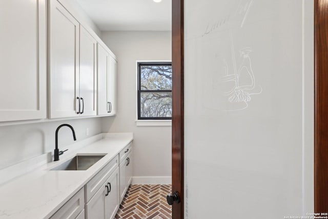 clothes washing area with sink