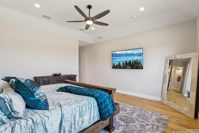 bedroom with ceiling fan and light wood-type flooring