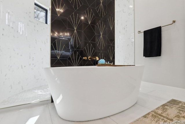 bathroom featuring tile patterned floors and a tub to relax in