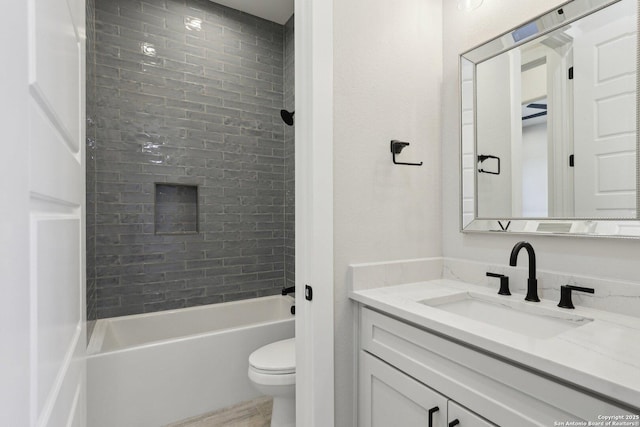 full bathroom featuring vanity, toilet, and tiled shower / bath combo