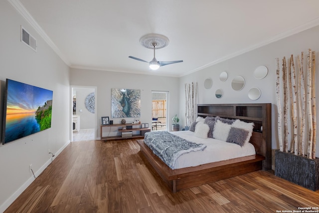 bedroom with hardwood / wood-style flooring, ceiling fan, and ornamental molding