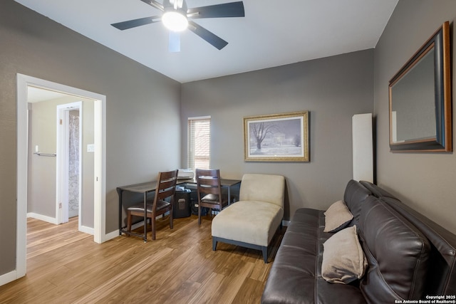 living room featuring ceiling fan and light wood-type flooring