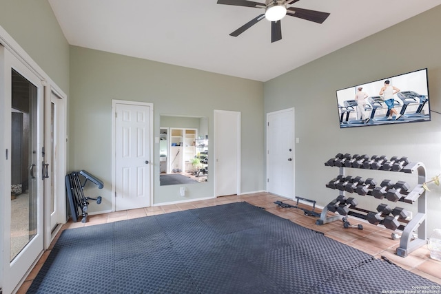 workout area featuring light tile patterned floors and ceiling fan