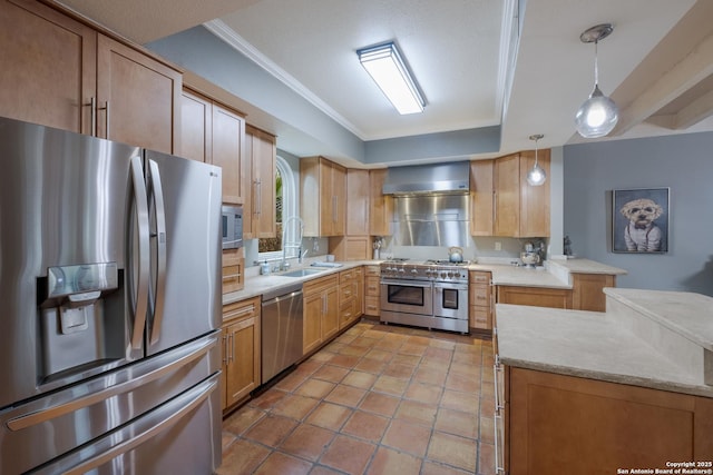 kitchen with pendant lighting, wall chimney range hood, stainless steel appliances, a tray ceiling, and kitchen peninsula