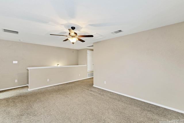 carpeted spare room featuring ceiling fan