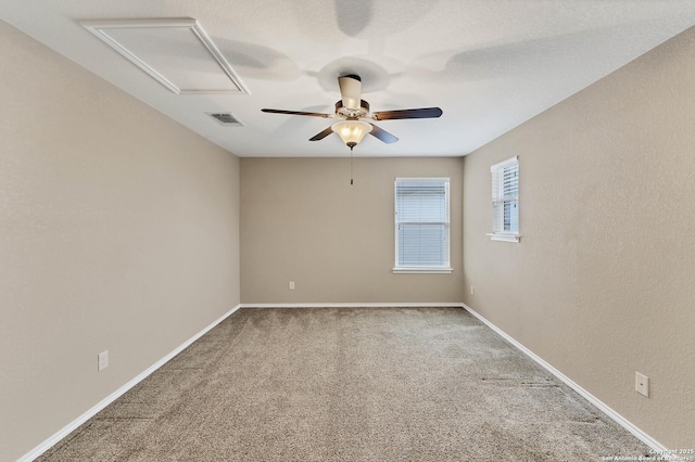 spare room with ceiling fan and carpet