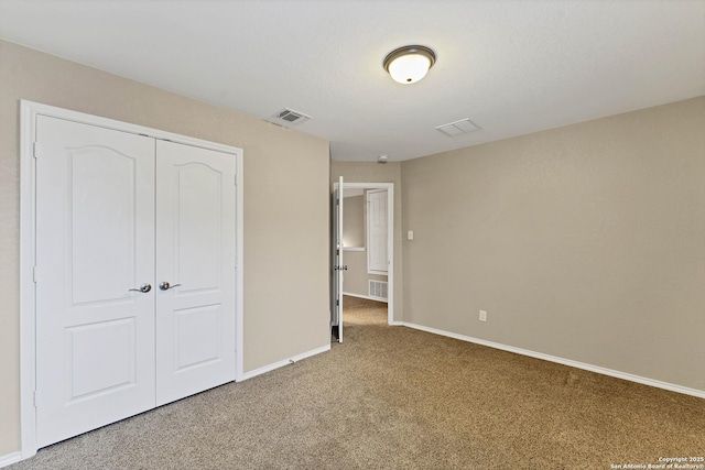 unfurnished bedroom with carpet floors and a closet