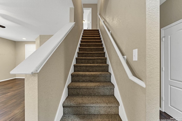 stairs featuring wood-type flooring