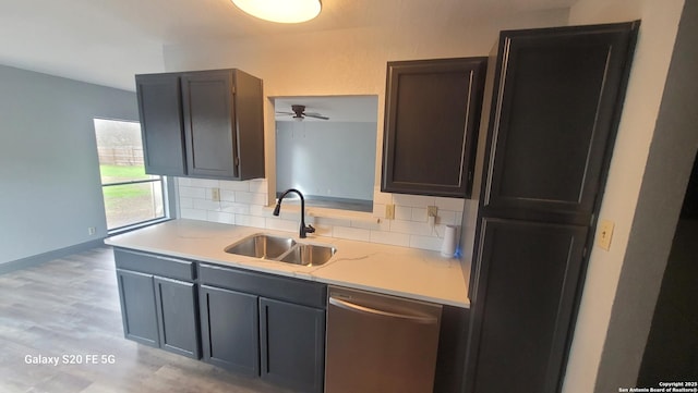 kitchen with tasteful backsplash, sink, light hardwood / wood-style floors, and dishwasher