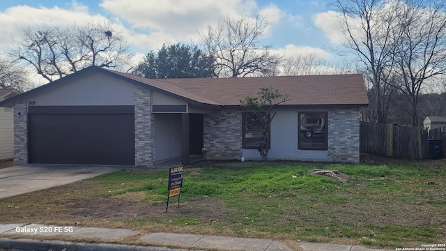 single story home with a garage and a front lawn