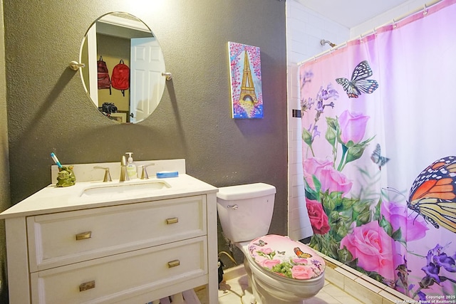 bathroom with vanity, toilet, and walk in shower