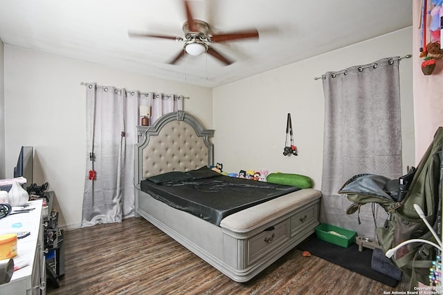 bedroom with dark wood-type flooring and ceiling fan