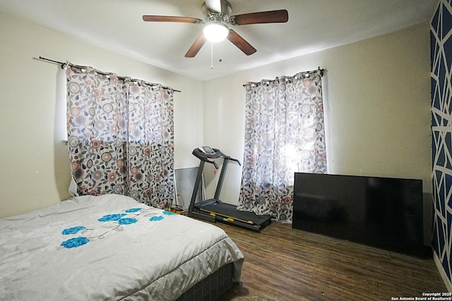 bedroom with ceiling fan and dark hardwood / wood-style flooring