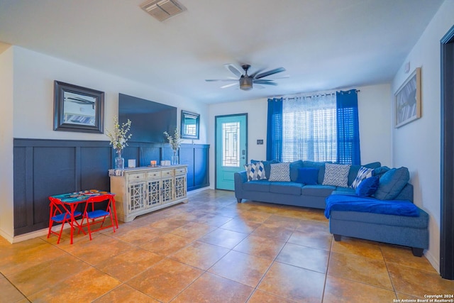 tiled living room with ceiling fan