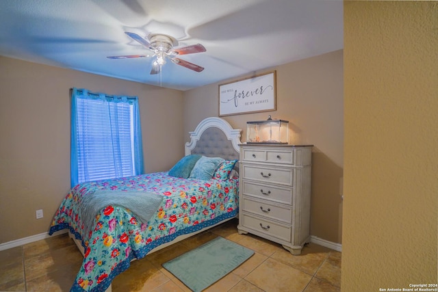 bedroom featuring light tile patterned floors and ceiling fan